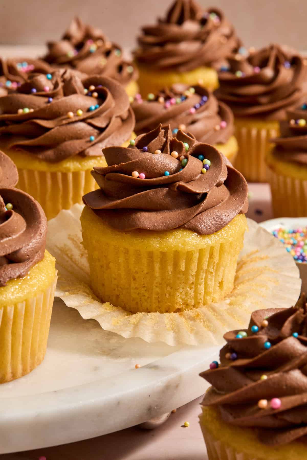 Wrapper pulled down off of box cake mix cupcakes to show texture.