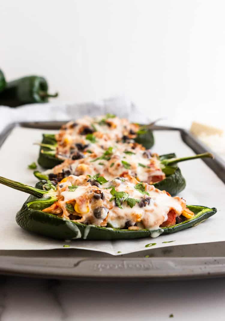 Chicken Stuffed Poblano Peppers on sheet pan with parchment.