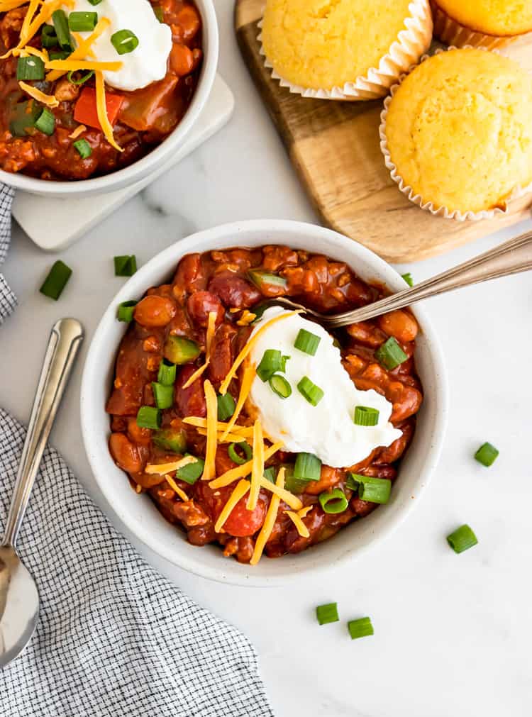 Turkey chili with shredded cheese, sour cream and green onions.