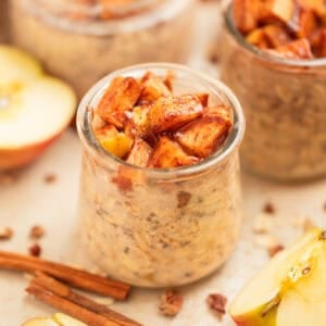 Apple overnight oats in jar topped with cinnamon apples.