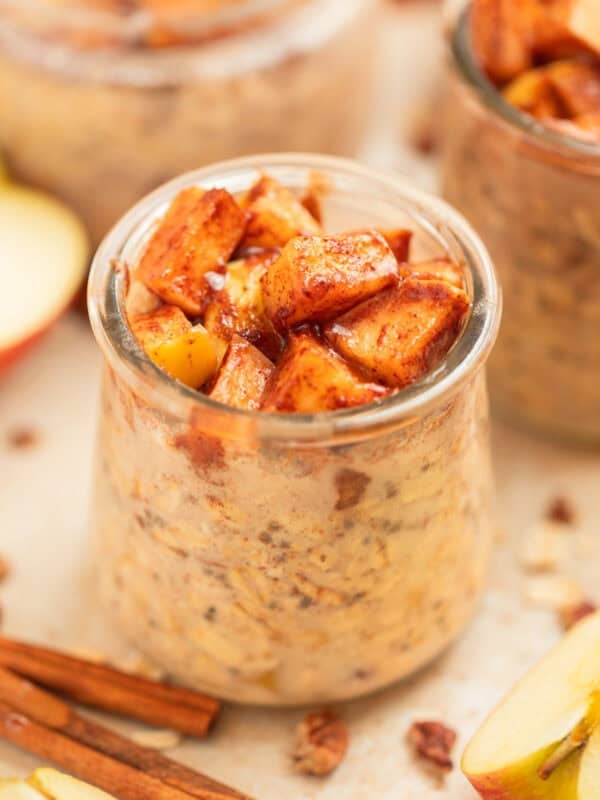 Apple overnight oats in jar topped with cinnamon apples.