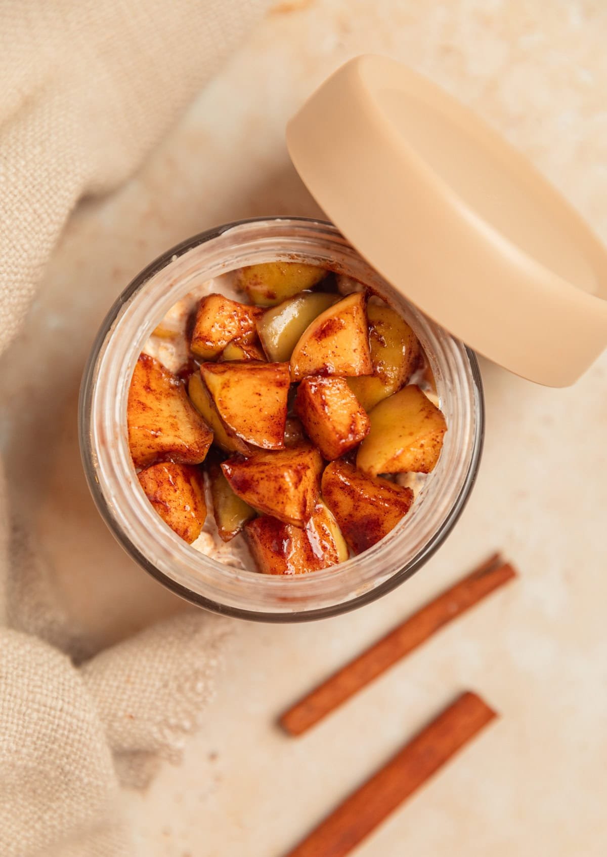 Jar with overnight oats topped with apples.