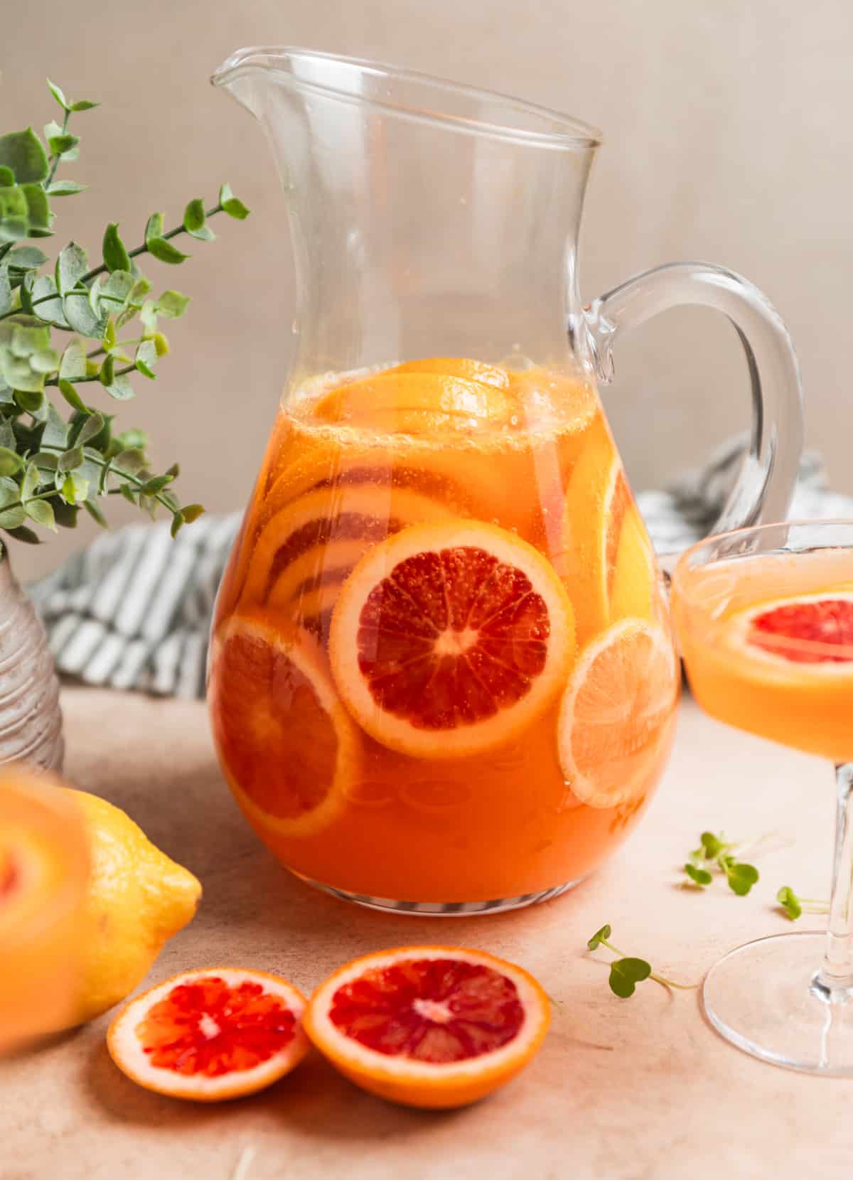 Pitcher of champagne sangria with blood oranges in it.