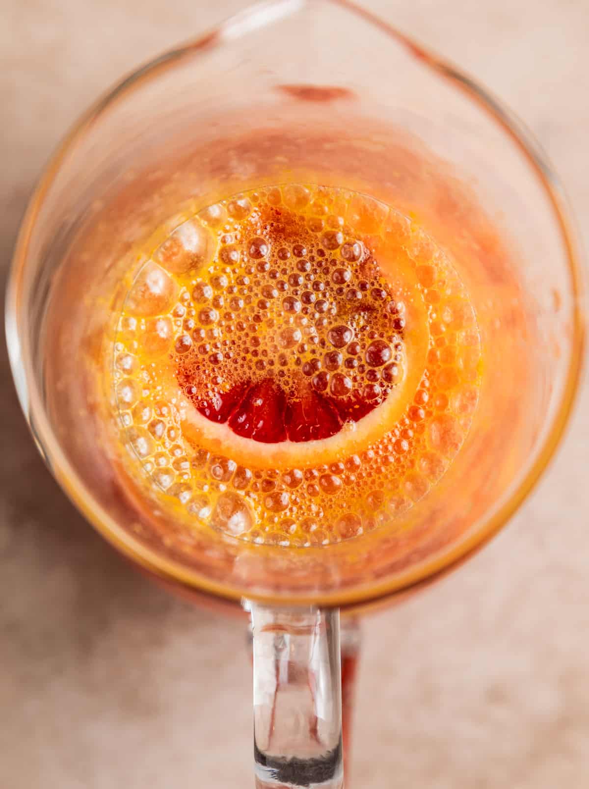 Pitcher with blood orange sangria, champagne just added.