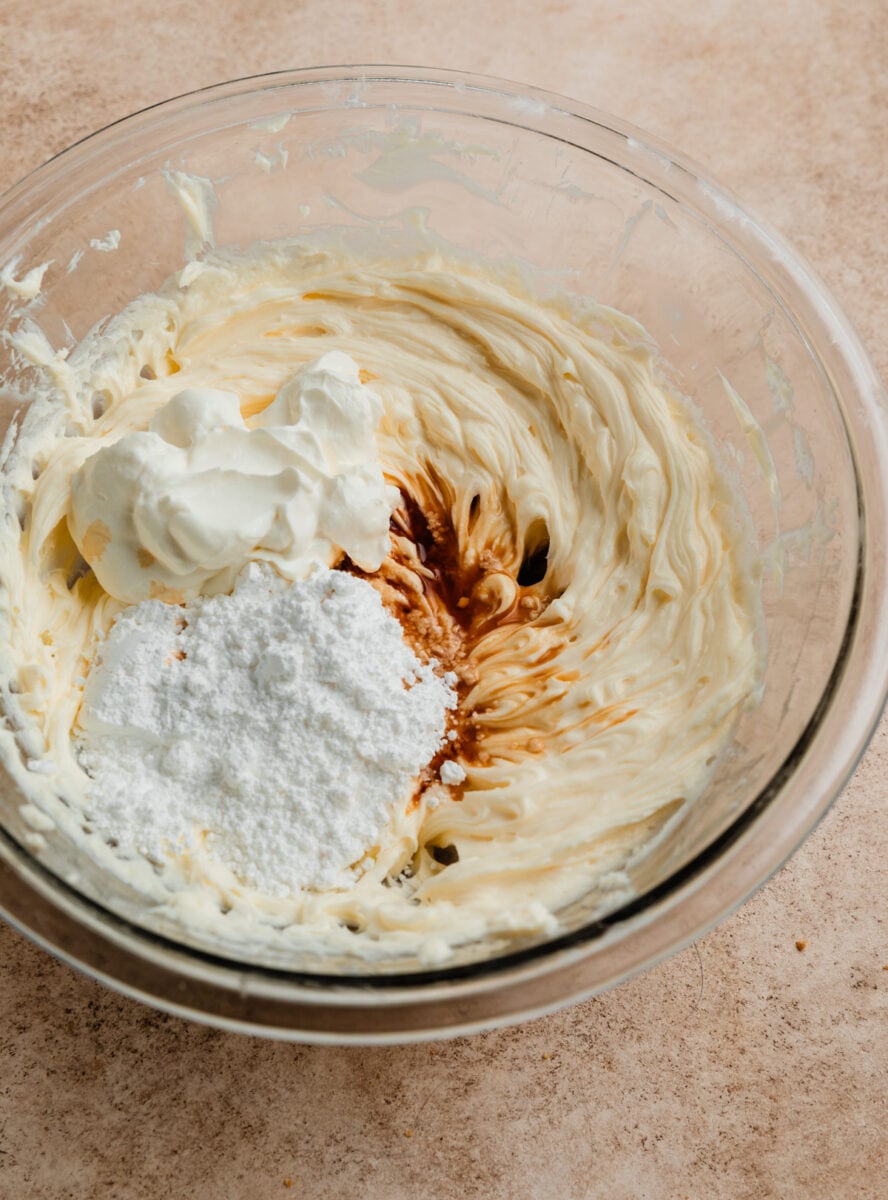 Vanilla, powdered sugar, and sour cream added to cheesecake mixture.