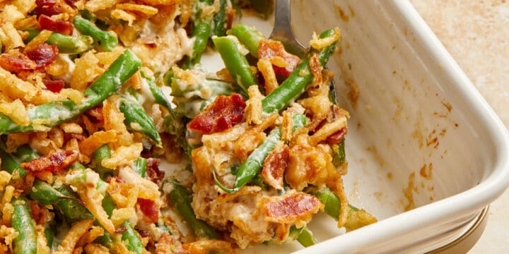 Bacon and green bean casserole in pan with serving spoon.
