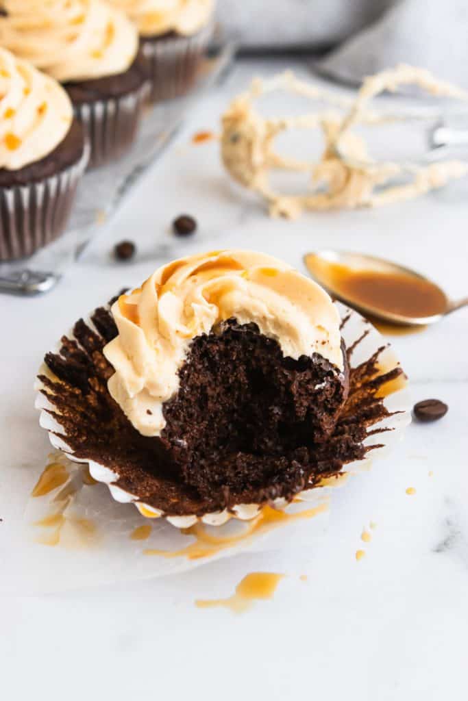 Mocha Cupcakes with bite taken and caramel frosting.