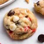 White and dark chocolate chip cookie with candy cane pieces.
