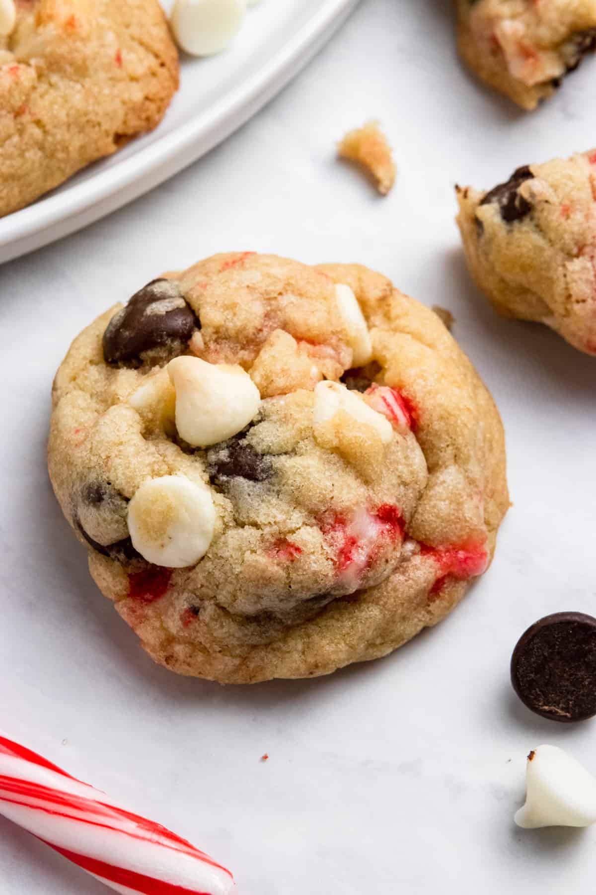 White and dark chocolate chip cookie with candy cane pieces.