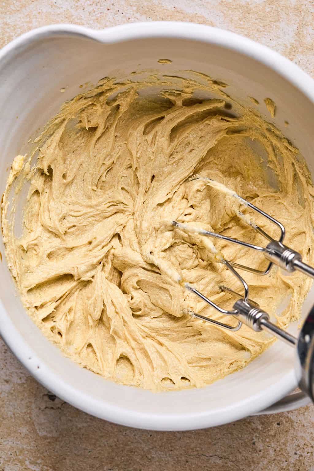 Cookie dough mixture in bowl with mixer.