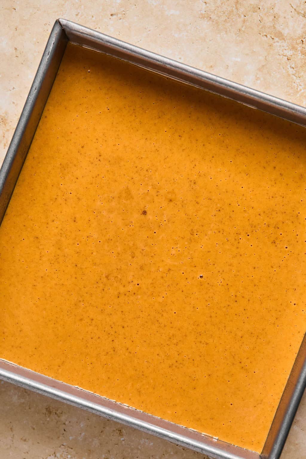Pumpkin layer in baking pan before baking.