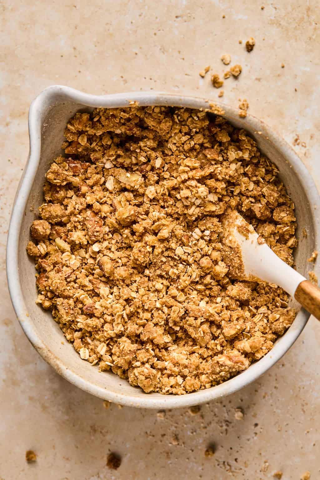 Prepared oat crumble topping in bowl before baking.