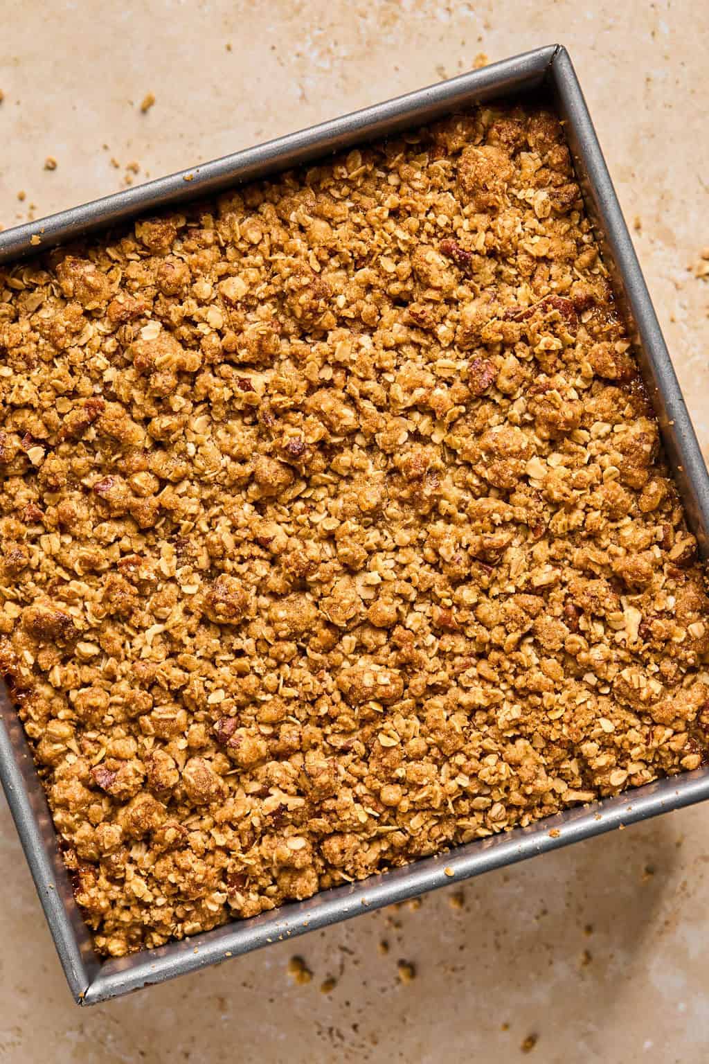 Baked pumpkin pie crumble in pan fresh from the oven.