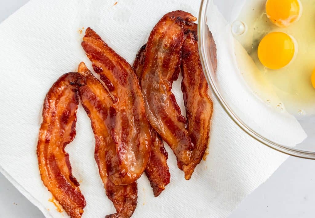 strips of maple bacon sitting on paper towel.