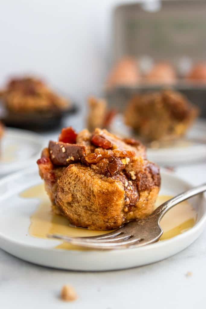 Plate with maple soaked french toast muffin and fork.