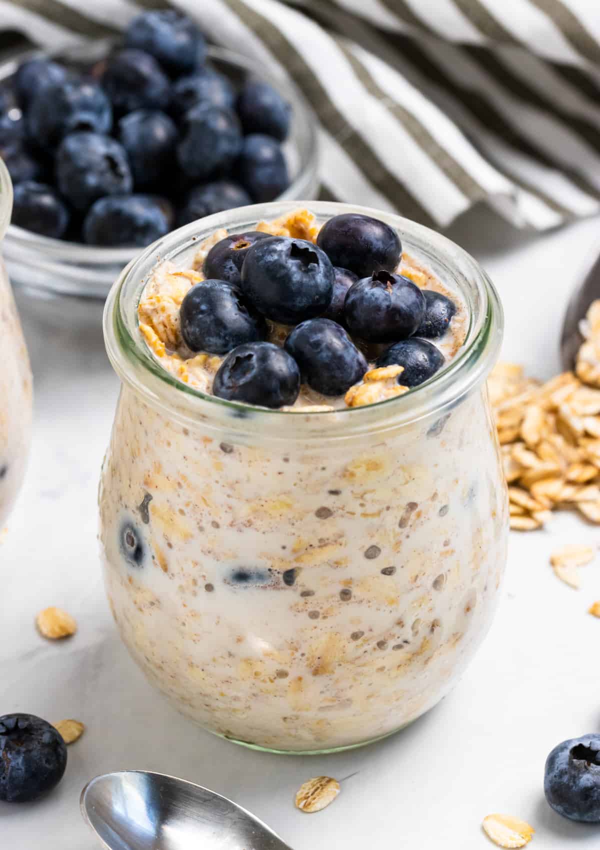 Oatmeal in jar with blueberries on top.