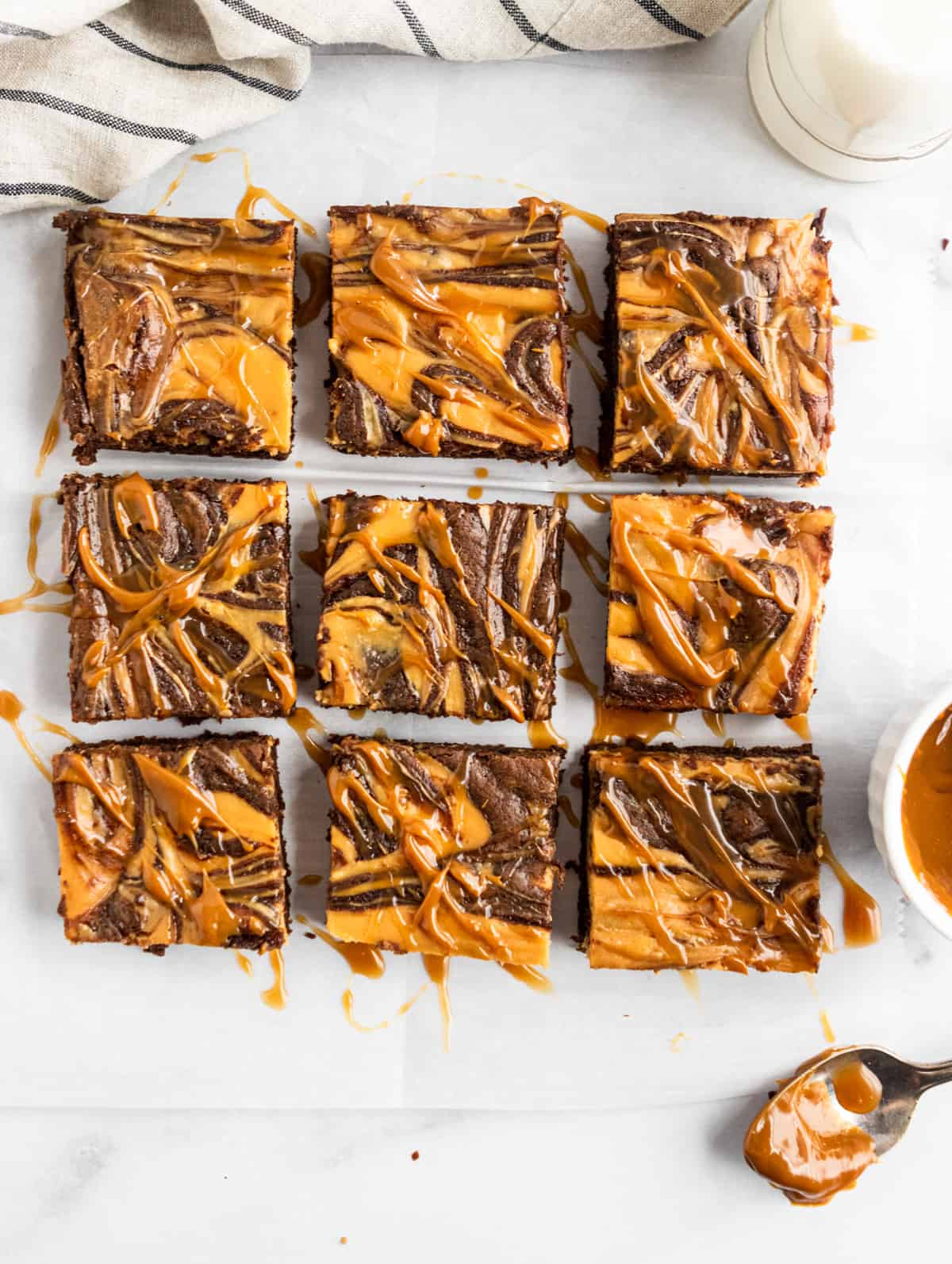Overhead shot of sliced brownies with dulce de leche drizzle.