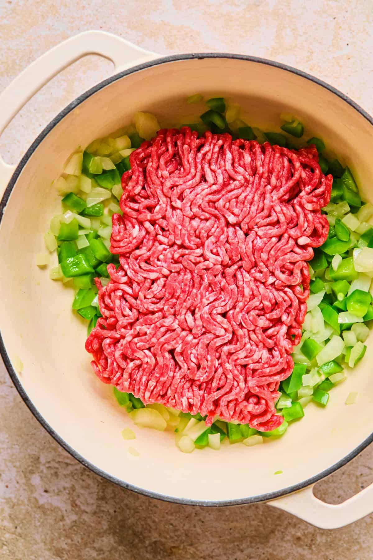 Pound of ground beef added to pot with onion and pepper.