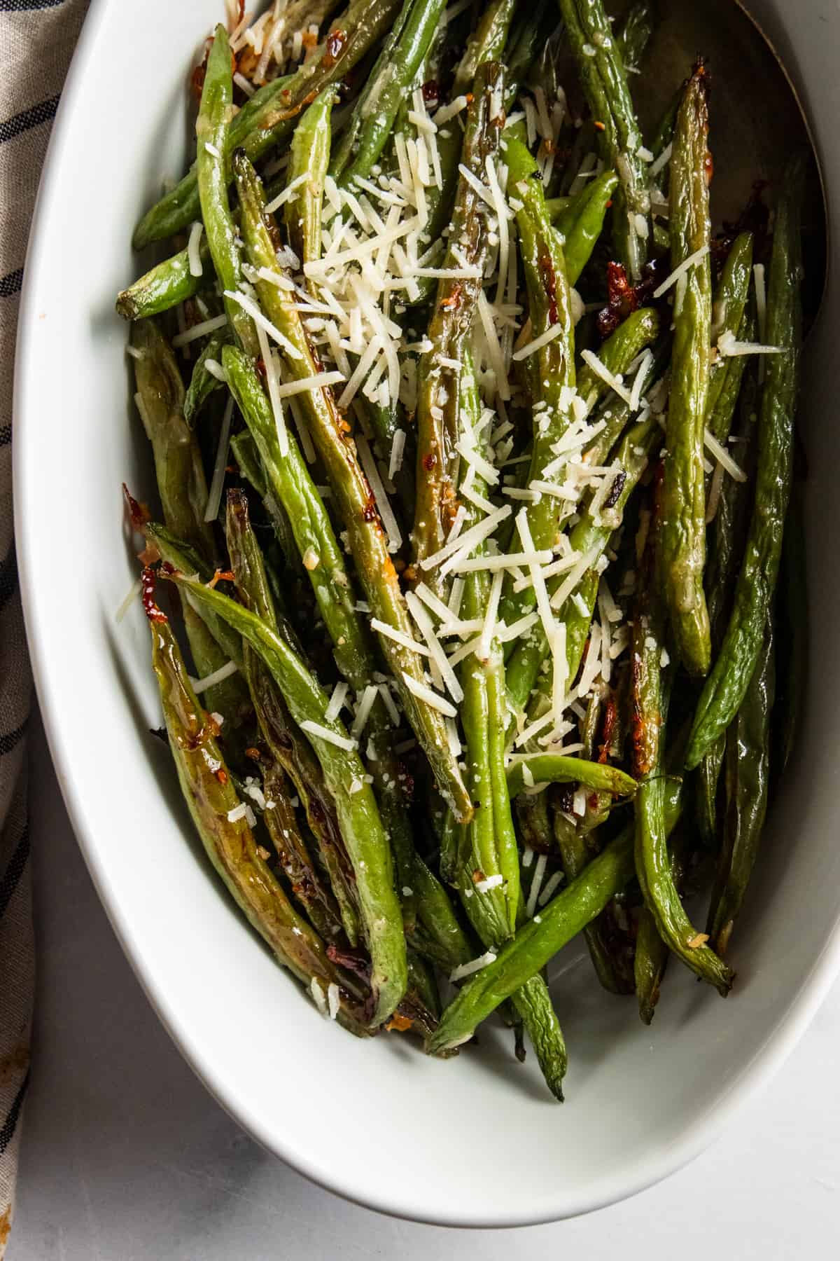 Roasted green beans in serving bowl.