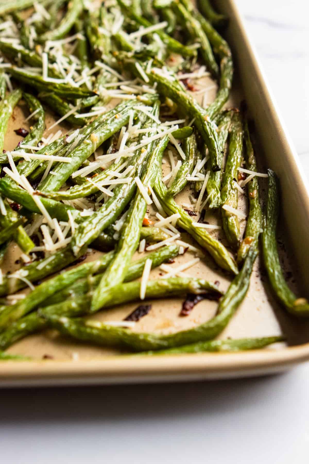 Baking sheet with roasted parmesan green beans.