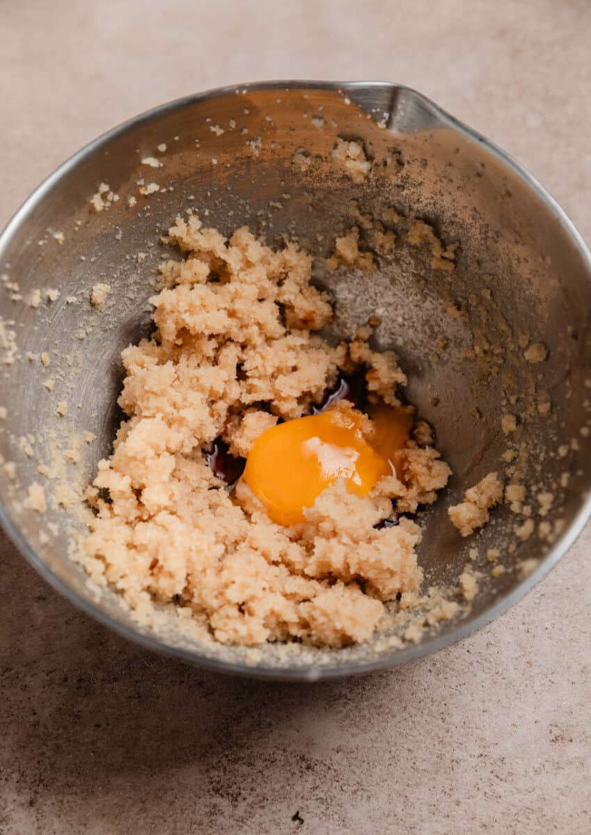 Creamed butter and sugar in mixing bowl with egg yolk and vanilla added.