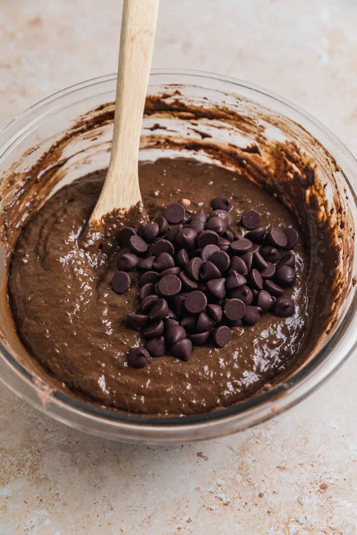 Chocolate chips added to chocolate spinach muffin mixture.