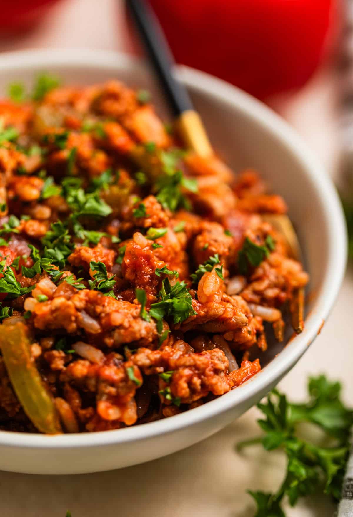 Bowl with ground turkey and pepper skillet dinner with chopped parsley over top.