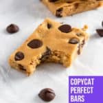 Peanut butter chocolate chip protein bar with bite out.