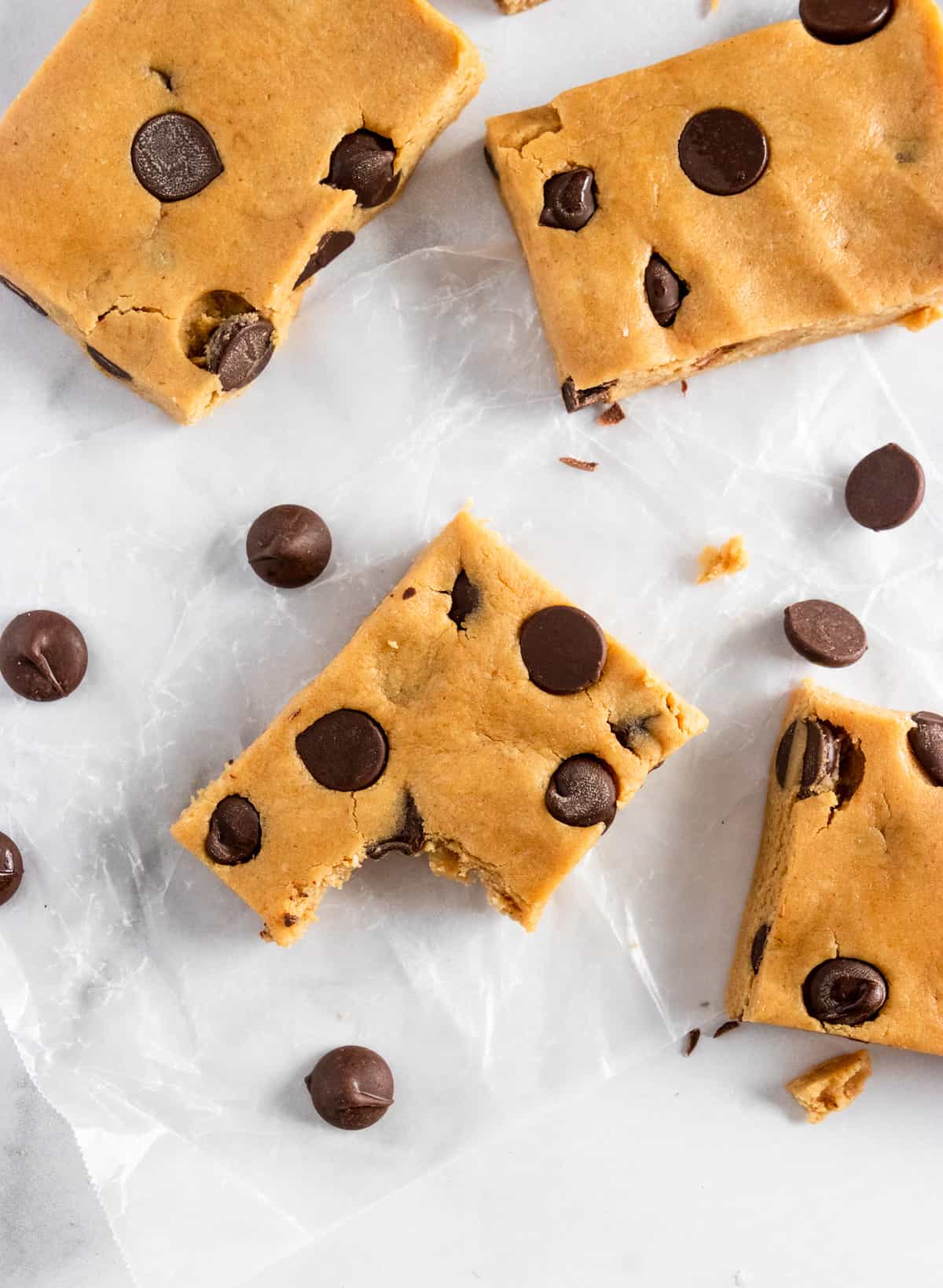 Bite shot of peanut butter chocolate chip bars with chocolate chips.