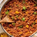 Simple ground turkey pepper skillet dinner in pan with wooden spoon.