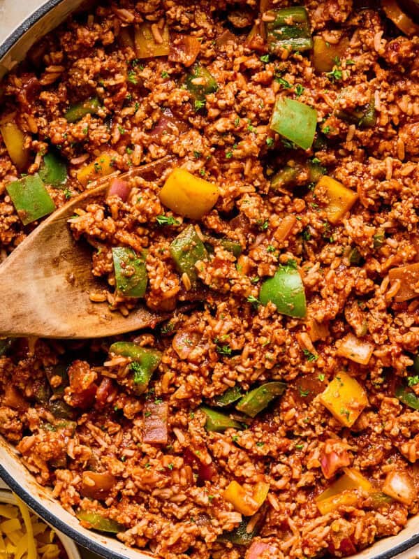 Simple ground turkey pepper skillet dinner in pan with wooden spoon.