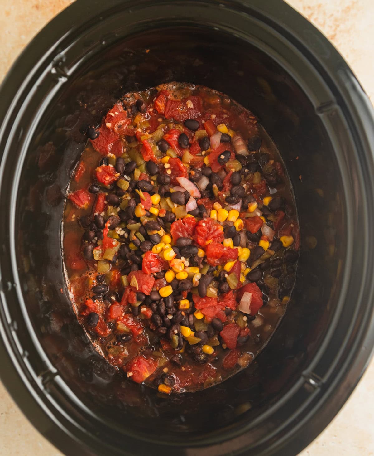 Cooked crockpot chicken burrito bowl mixture before shredding chicken.