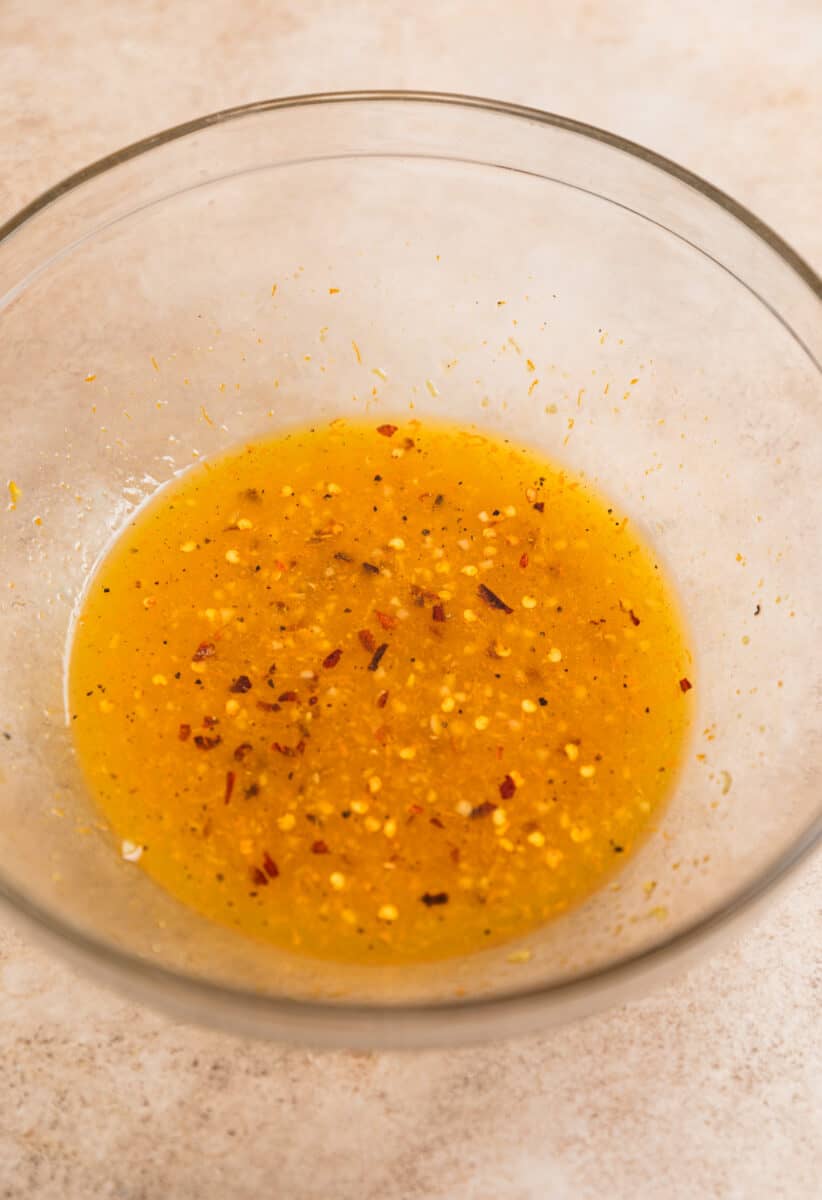 Orange chicken marinade in glass mixing bowl.