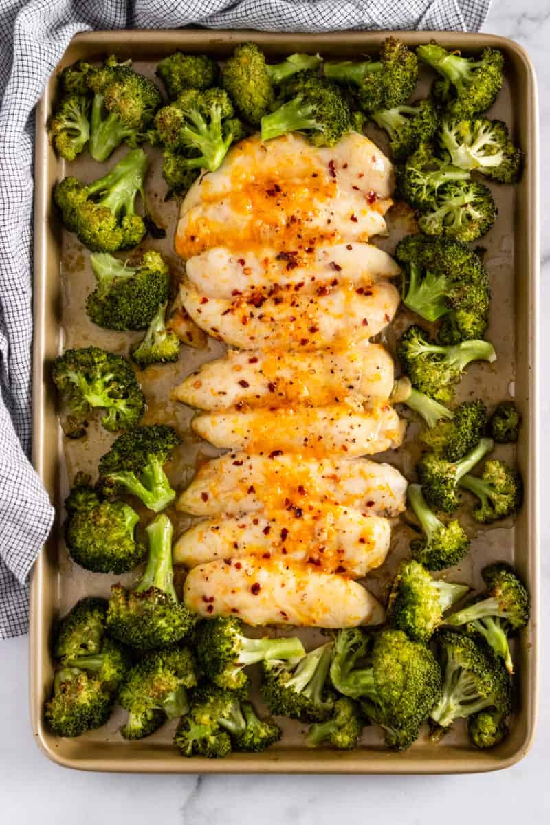 Sheet pan dinner cooked with orange chicken and broccoli.