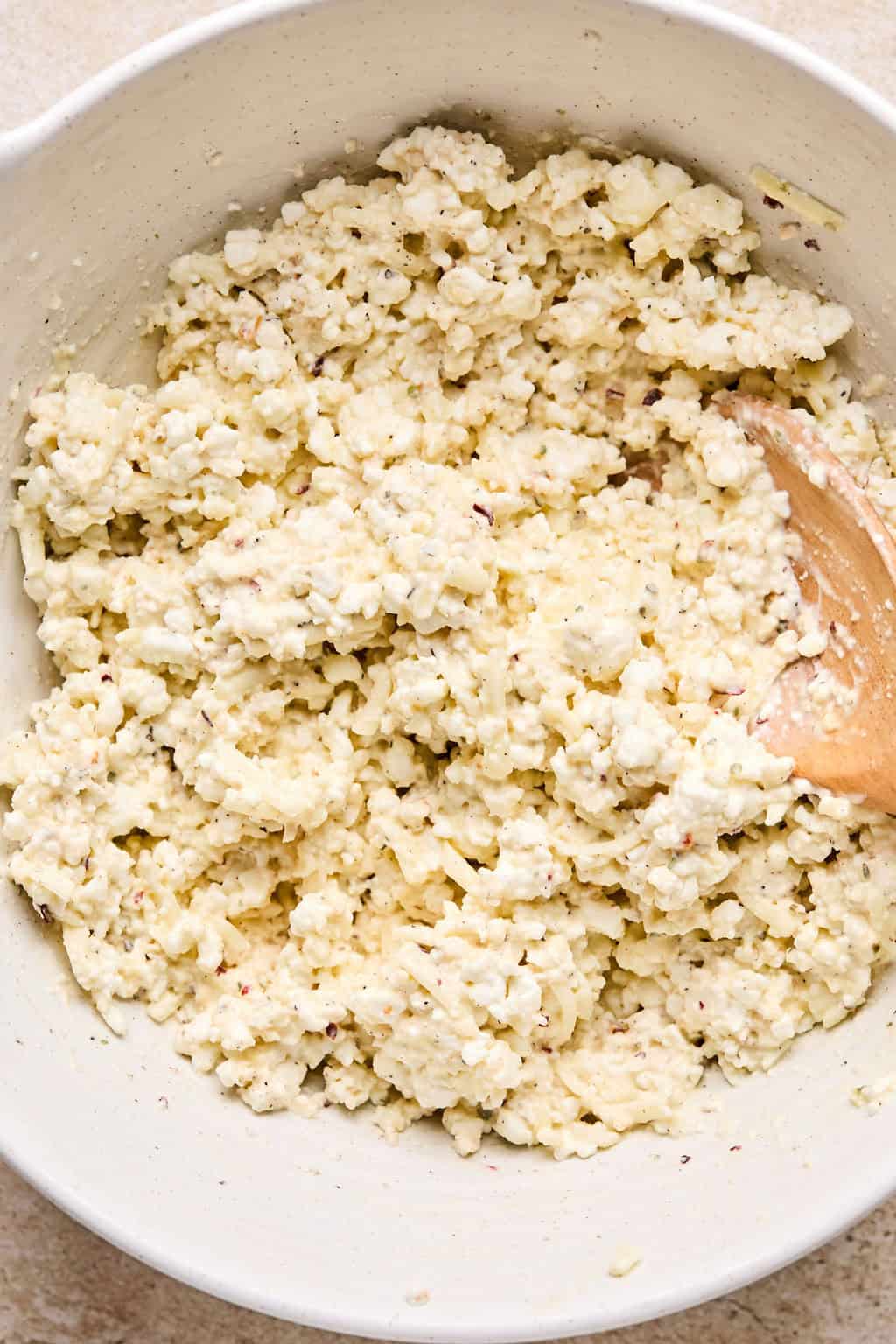 Cottage cheese mixture in bowl with seasoning.
