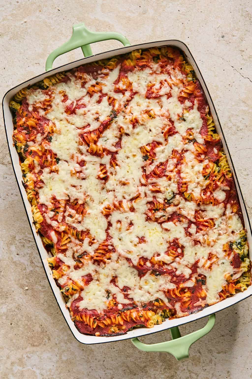 Baked pasta fresh from the oven with melted mozzarella cheese on top.