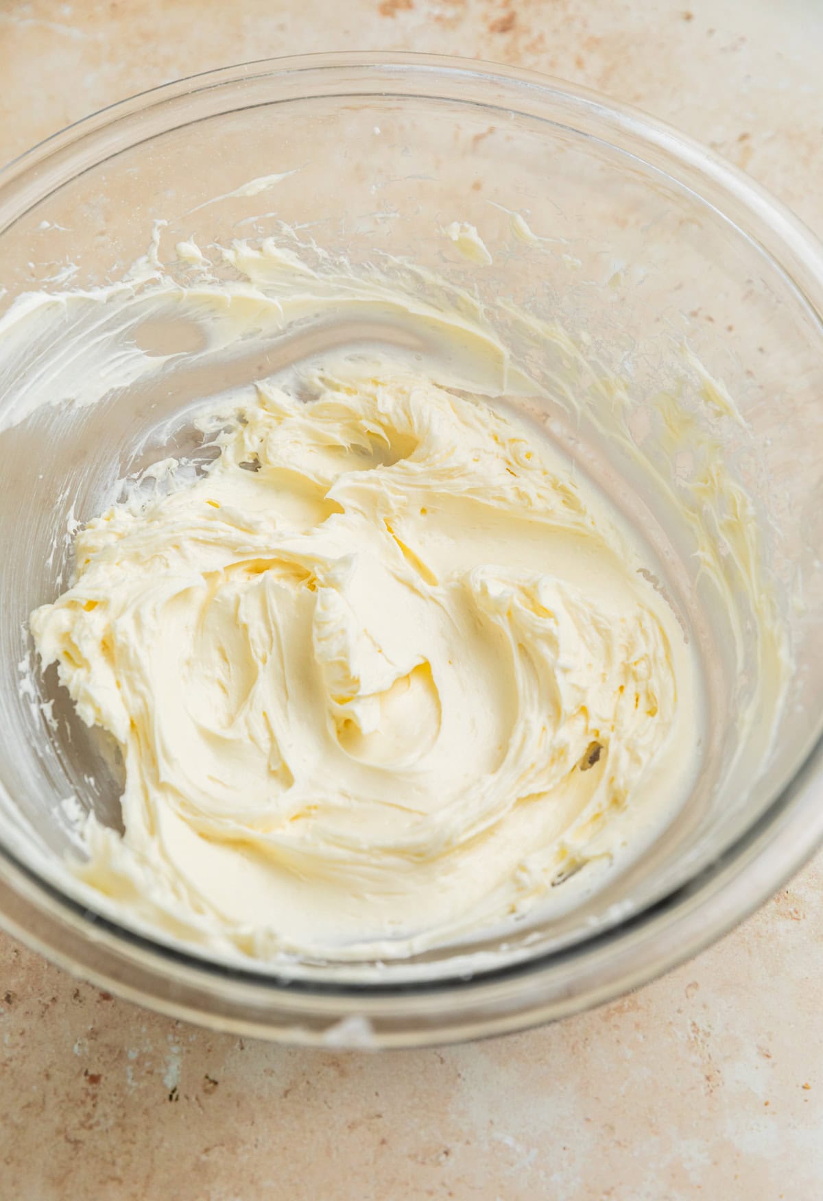 Creamed cream cheese and powdered sugar in mixing bowl.