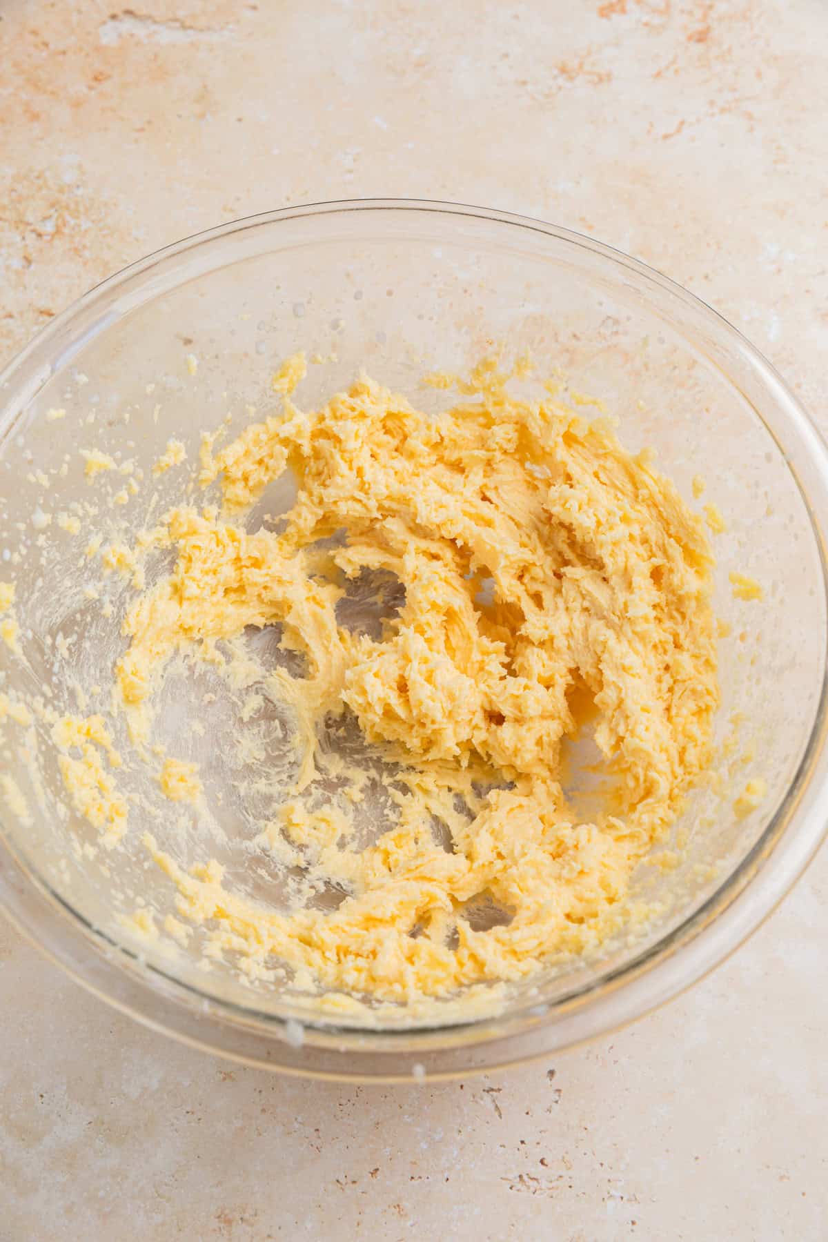 Milk and vanilla added to creamed butter and sugar in bowl.