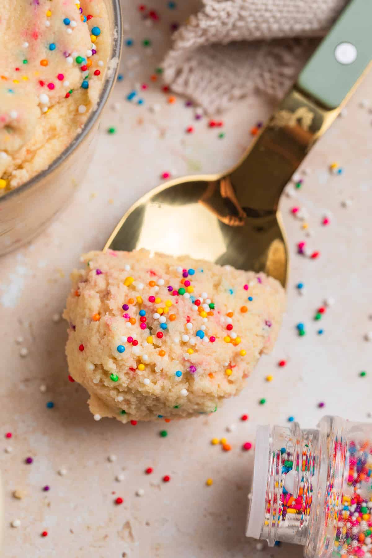 Spoonful of sugar cookie dough with nonpareils.