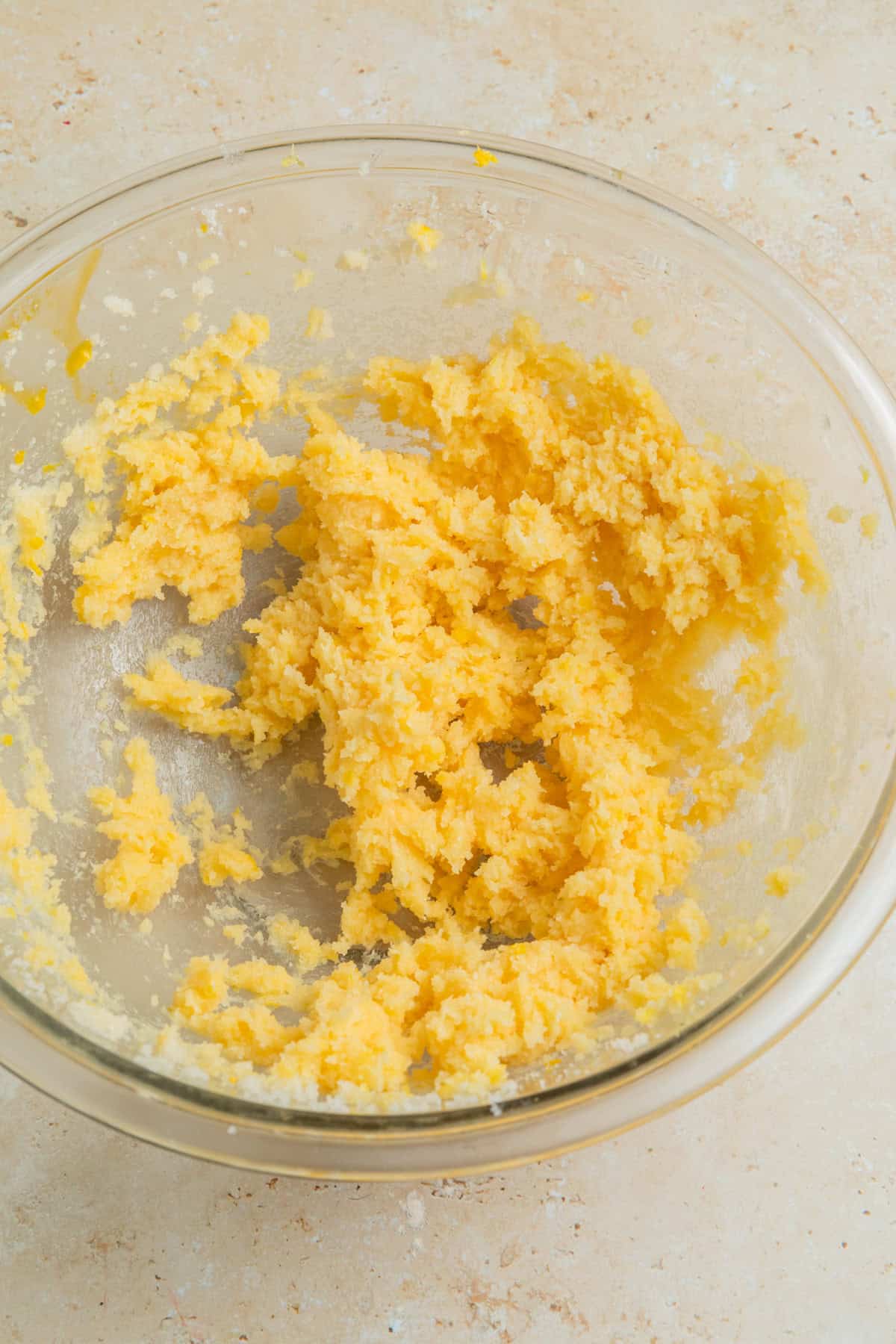 Lemon zest, vanilla and egg yolk mixed into creamed butter and sugar.