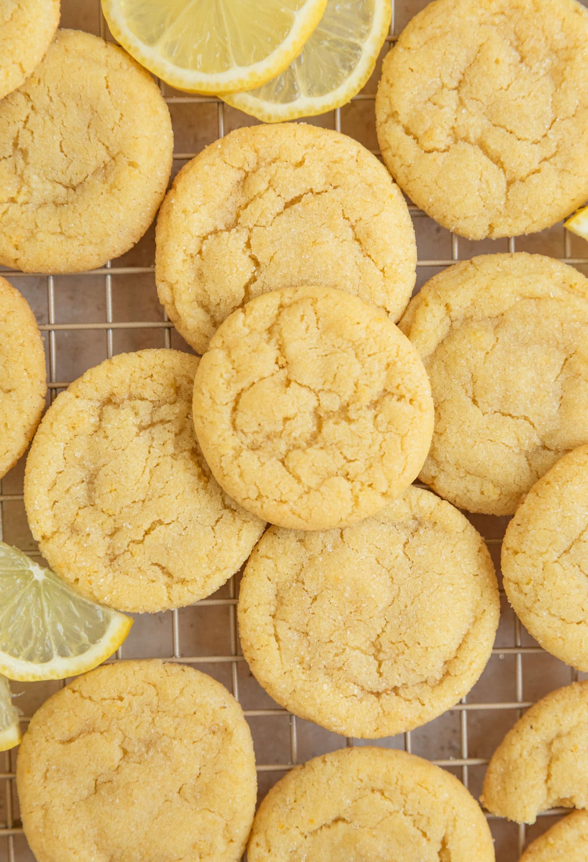 Wire rack with lemon cookies and lemon slices.