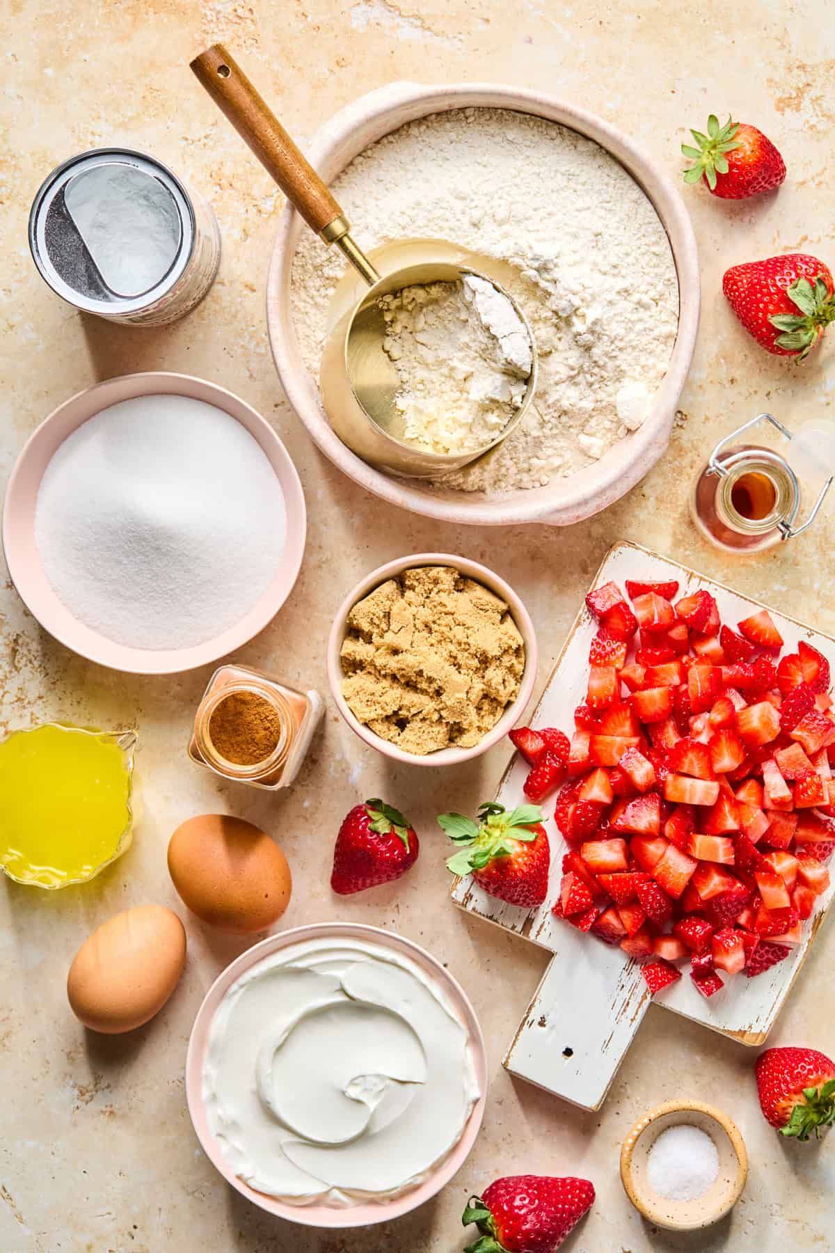 Chopped strawberries, flour, butter, sugar and other ingredients for recipe.