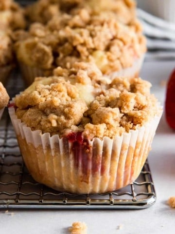 Strawberry Muffin with crumble topping on cooling rack.
