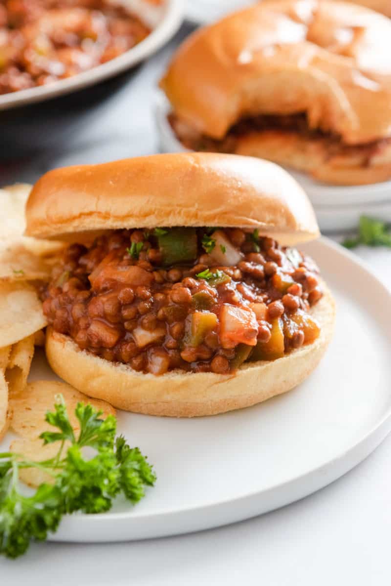 Vegan sloppy Joes on bun with chips.