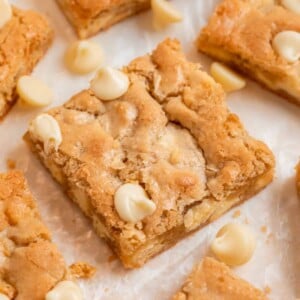Almond flour blondies on parchment with white chocolate chips.