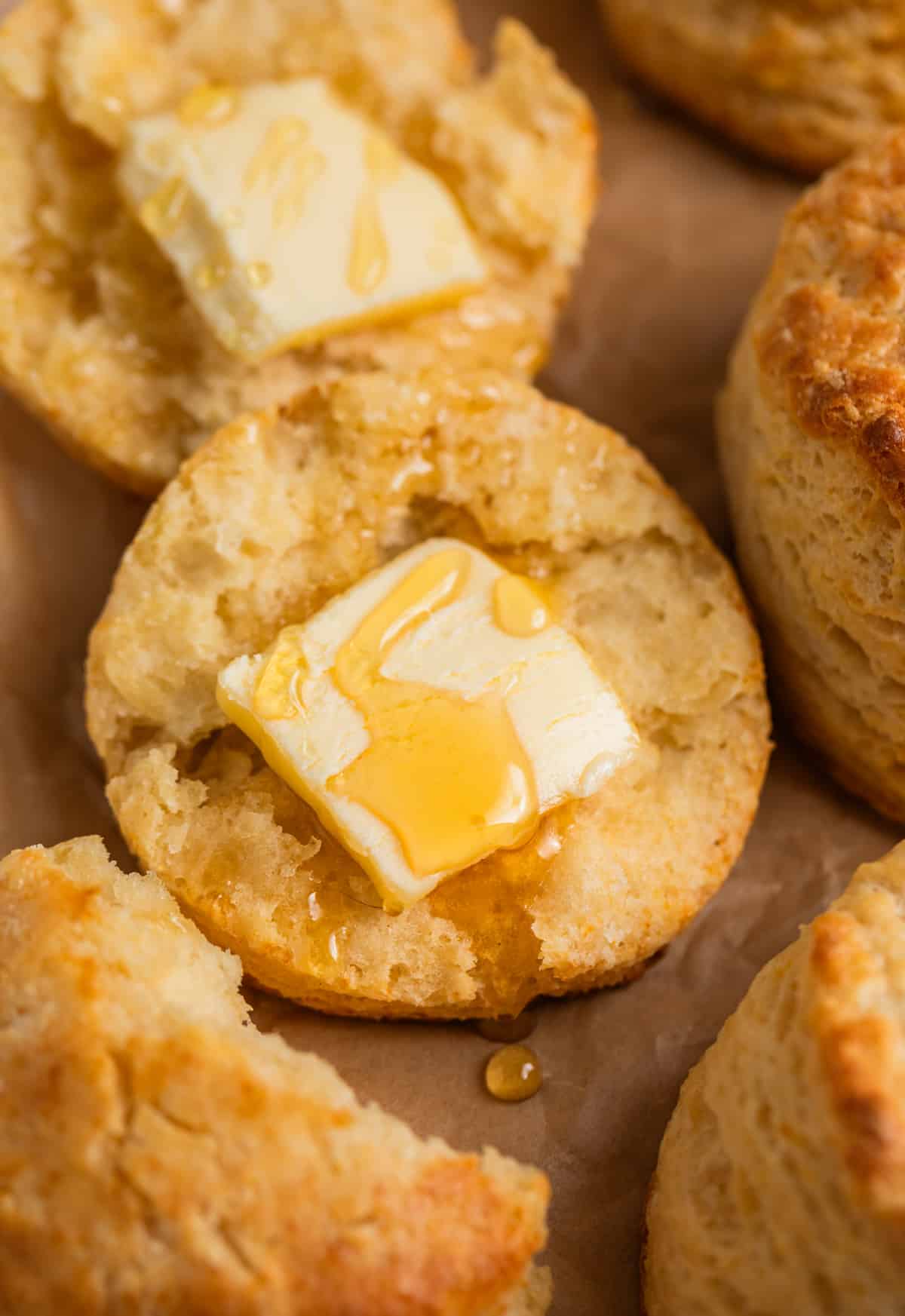 Split honey biscuit with pad of butter and drizzle of honey on top.