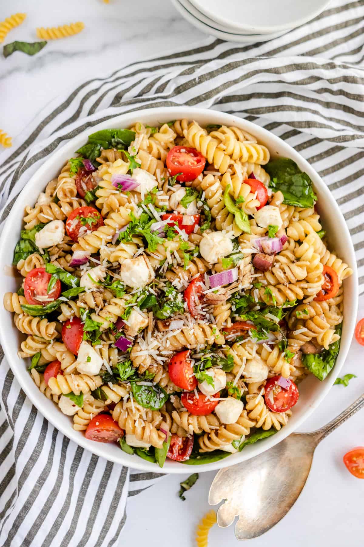 Overhead shot of rotini pasta salad with serving spoon.