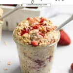 Overnight oats in jar with strawberries and spoon.