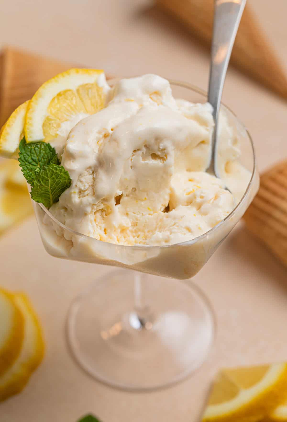 Dish with half of a serving of lemon ice cream and spoon placed in the dish.