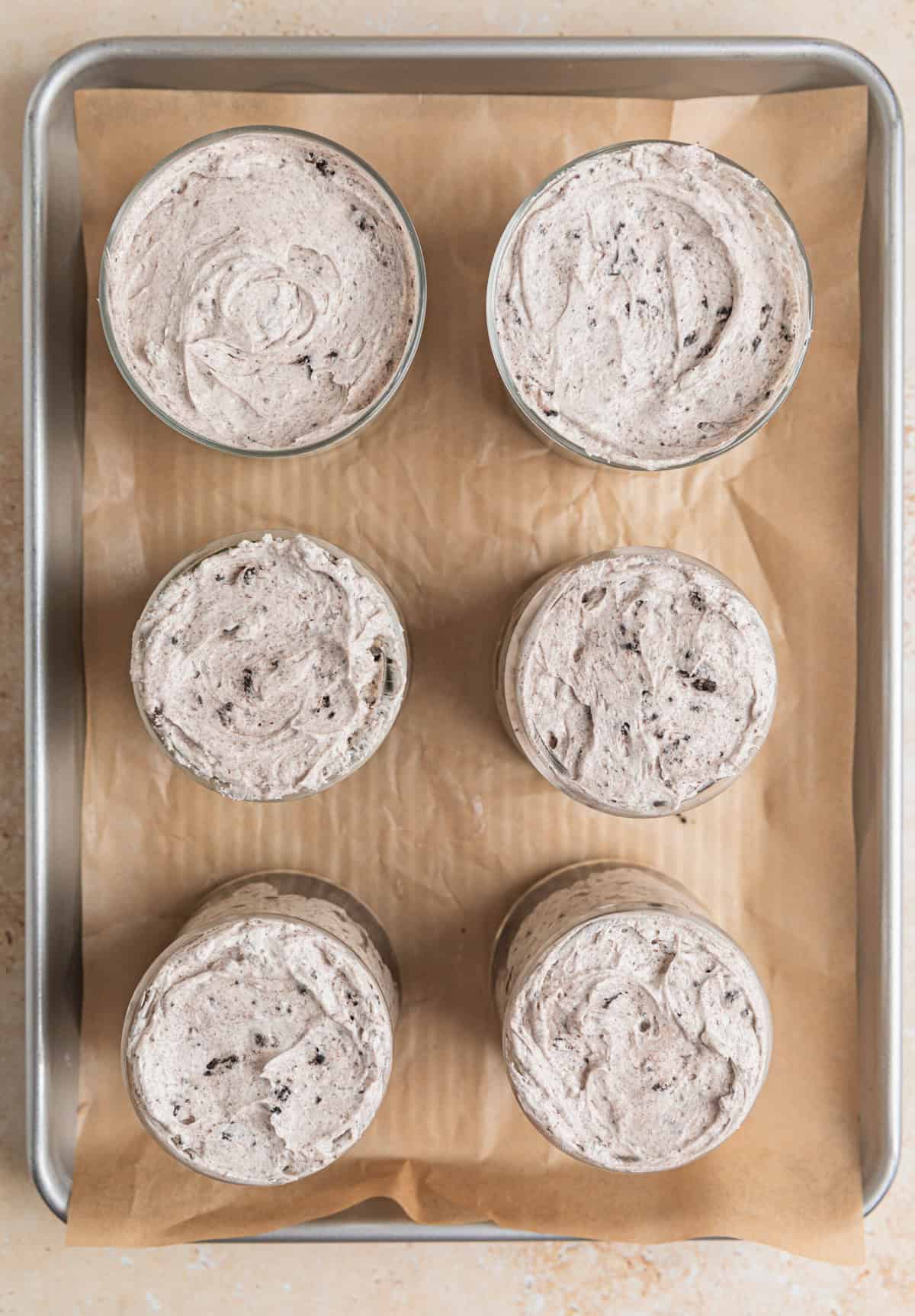 Glass dishes filled with no bake Oreo cheesecake.